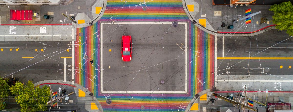 overhead shot of care with rainbow crosswalks